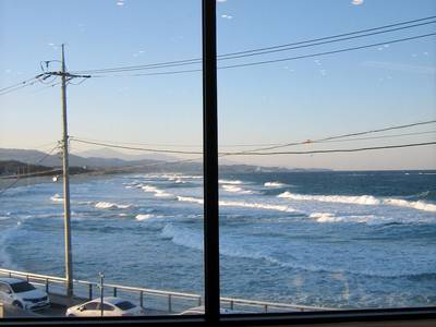 The ocean and a power line seen through a large window