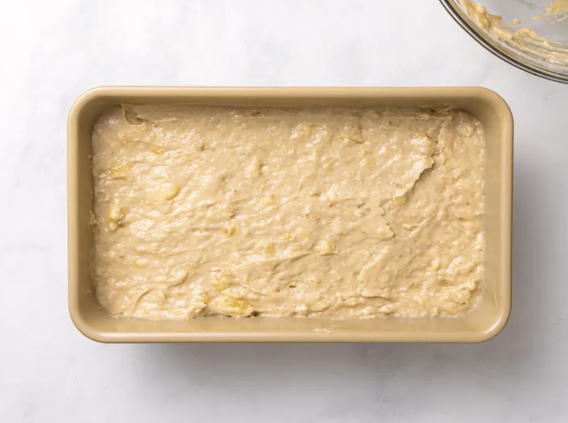 Banana bread batter spread evenly in a loaf pan
